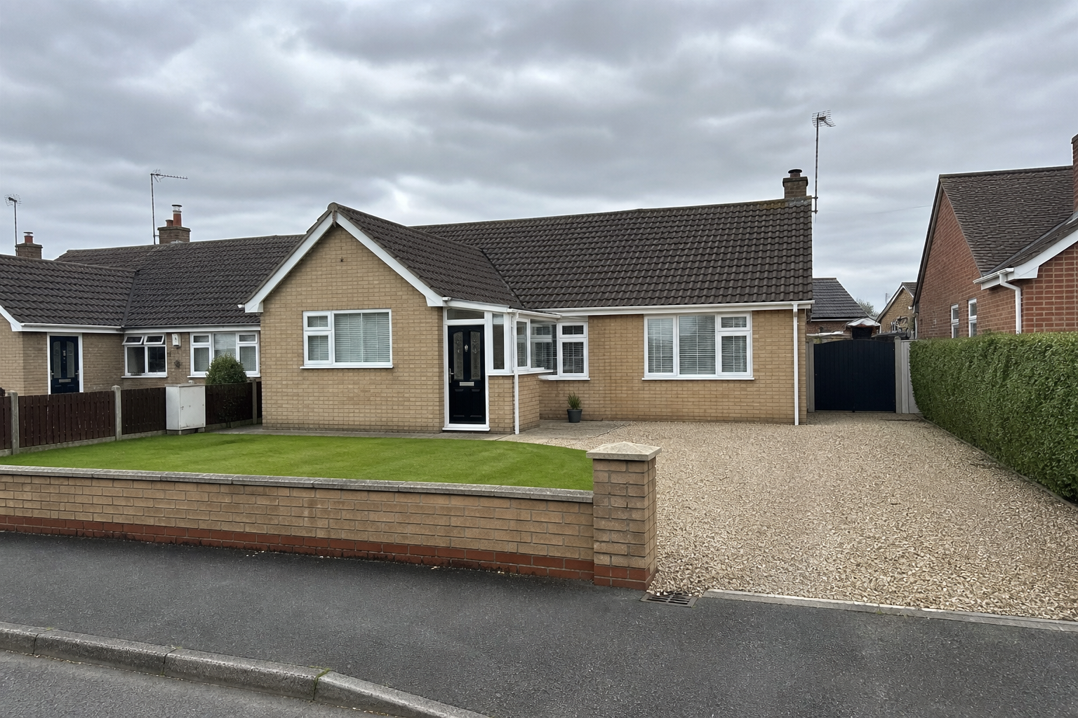 3 Ploughlands, Haxby: a buff-brick bungalow with a brown tile roof, white uPVC and a gravel drive, and no shop fascia