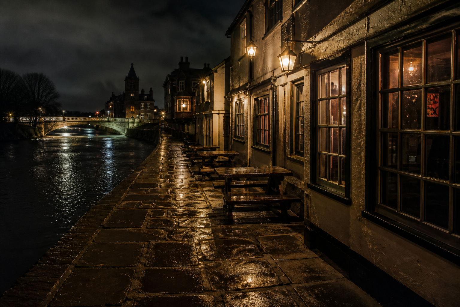 A historic York riverside quay at night, with lantern light and no readable signs
