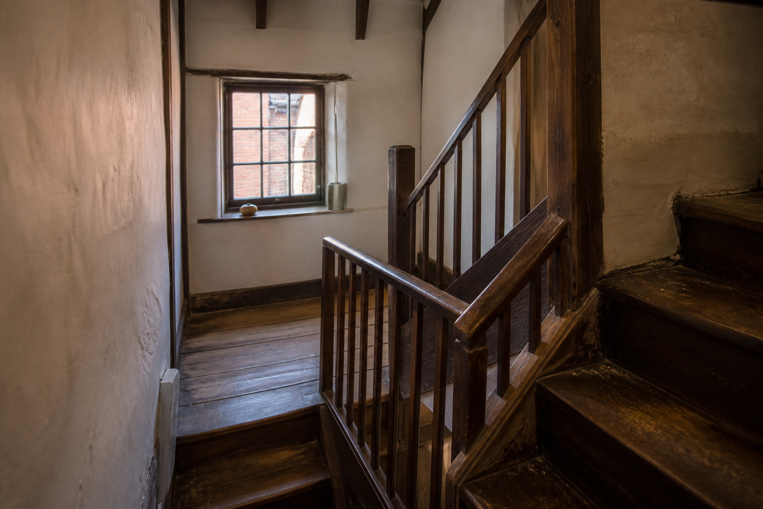 A timber staircase in a narrow York building used as a studio, with no people