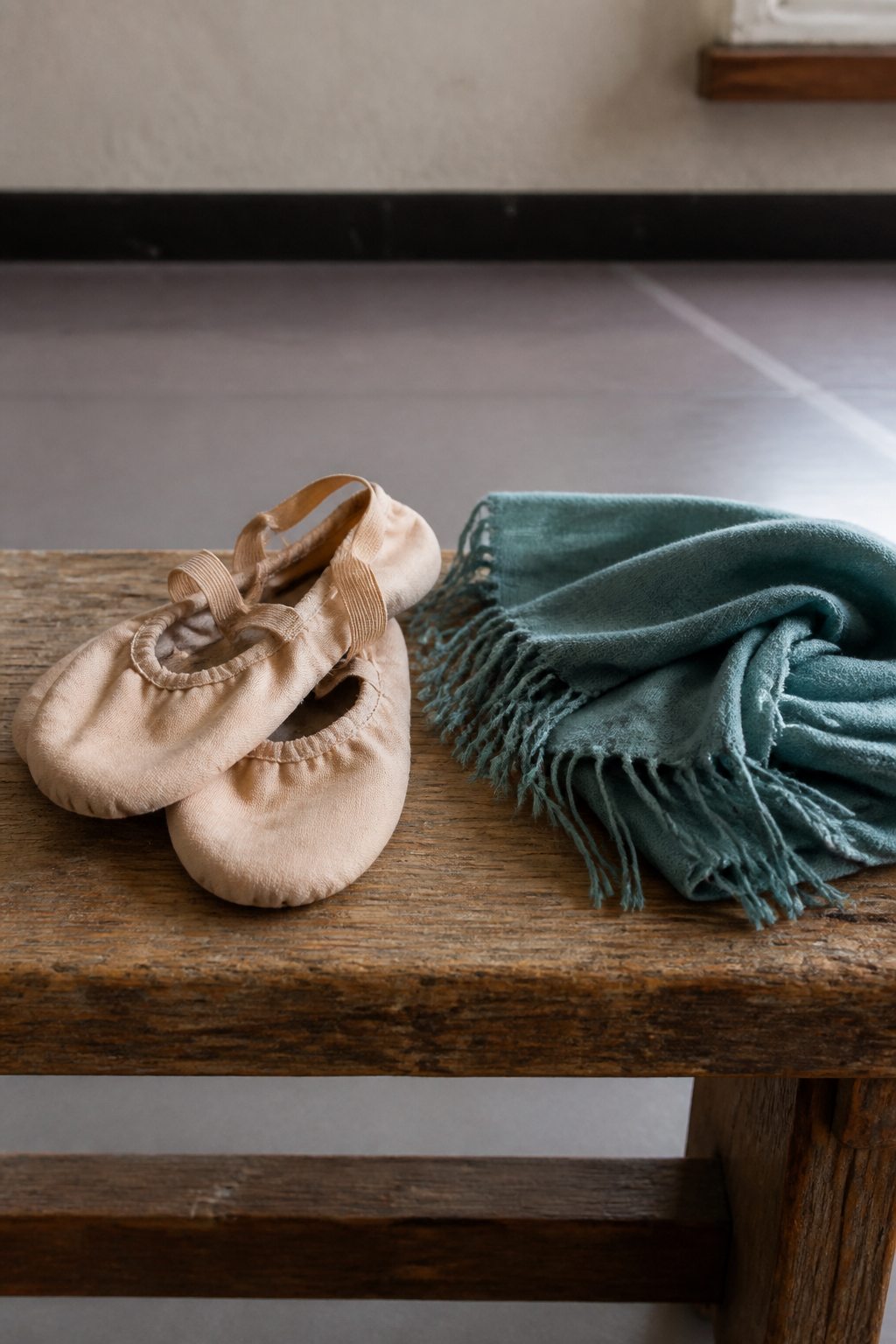 Soft dance shoes on a wooden studio bench, with no logos